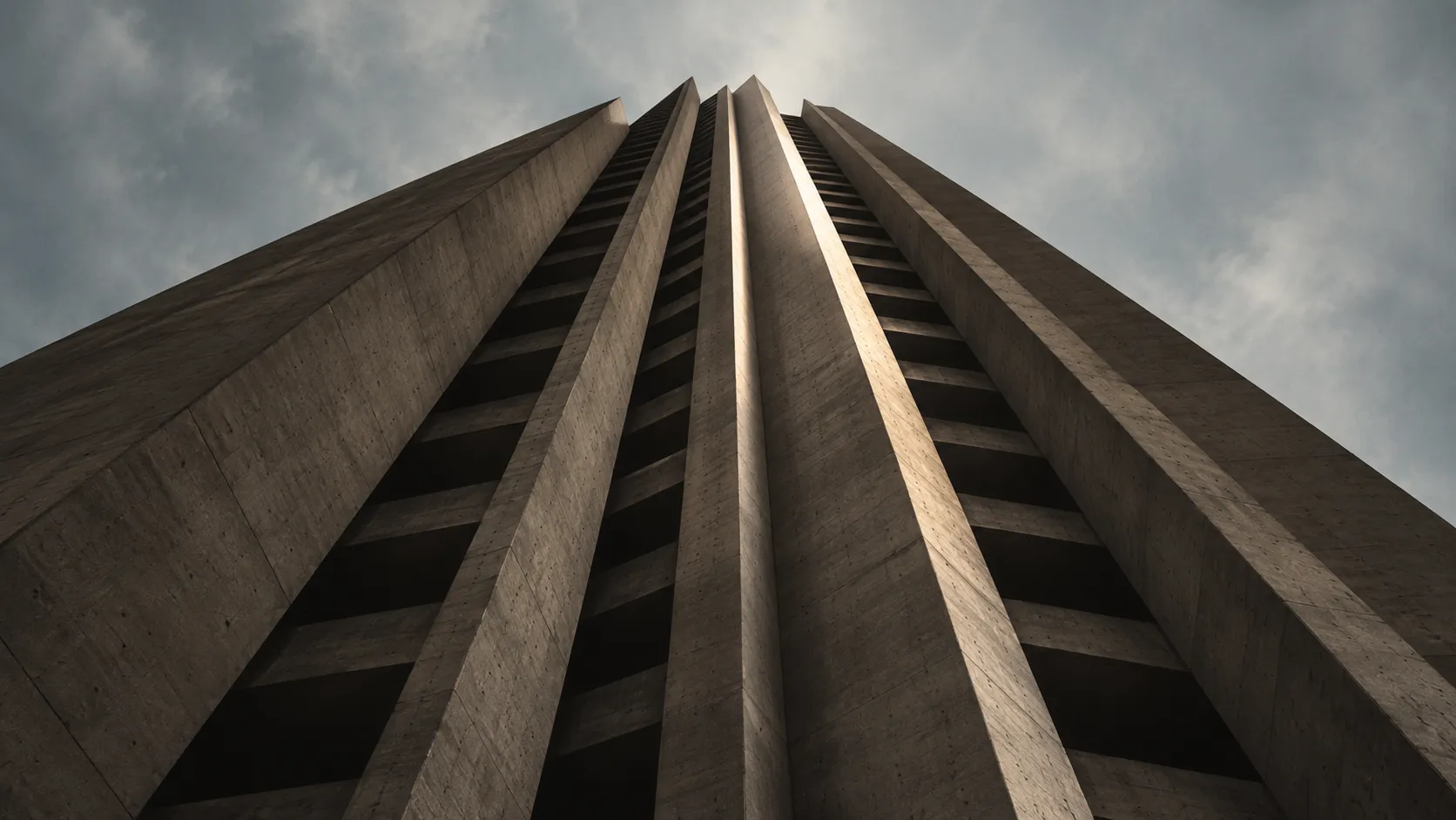 A concrete tower seen from its base, ribs converging into the sky.